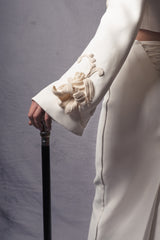 white jacket and skirt set adorned with three-dimensional crochet flowers