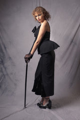 black high-waisted fitted skirt featuring a silk velvet flared slit