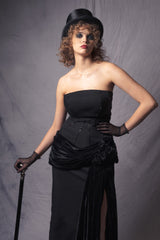 off-shoulder black dress withs a beaded corset top and a silk velvet basque, accentuated by a high slit