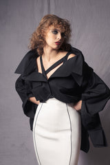 black oversized shirt with asymmetric straps that slide down exposing the shoulders