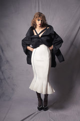 white pencil skirt with a wavy hem with two black stripes on the front that complement the figure contours