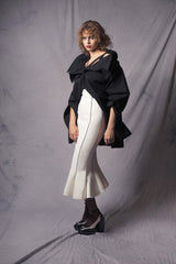 white pencil skirt with a wavy hem with two black stripes on the front that complement the figure contours