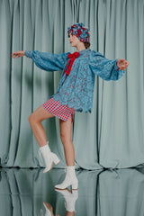 luxury kids clothing Hip-length lace blouse fully lined with contrasting red silk satin with bishop sleeves and a scarlet statement bow. Hand made pleats that drop down from the yoke.