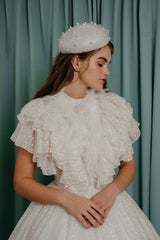 couture for kids spectacular bodice has rich layers of delicate white polka dot silk ruffles that mix with natural ostrich feathers