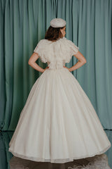 couture gowns for kids romantic ruffled top with magnificent texture and natural ostrich feather trim.