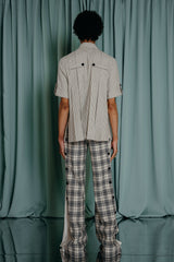 couture clothing for kids trousers with classic navy blue and off-white plaid pattern and a softly textured off-white cotton . Navy blue velvet buttons all the way down both sides of the trousers. Front fastening - zipper and a velvet button.