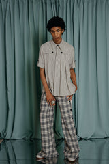 luxury kids clothing Flared trousers with classic navy blue and off-white plaid pattern and a softly textured off-white cotton . Navy blue velvet buttons all the way down both sides of the trousers. Front fastening - zipper and a velvet button.