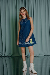 couture for teens luxuriously fun denim A line mini dress with hand painted water and a little yellow bath duck swimming happily among the crystal embellished water drops. Peter Pan collar embellished with various sized crystals and transparent resin pearls. Pockets on the sides