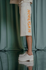 couture clothing Denim below-the-knee shorts with a signature lettering on the side.  Hand-painted.