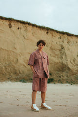 Relaxed-fit, wide-leg linen shorts with front button closure and two silk-lined pockets.