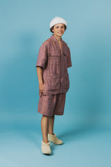 Relaxed-fit, wide-leg linen shorts with front button closure and two silk-lined pockets.