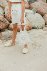 Graceful white denim A-line mini skirt, softly tailored and embellished with decorative pebbles