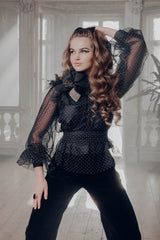 Artistic take on the classic polka dot pattern in a belted sheer blouse with a rounded sunburst neckline and bishop sleeves