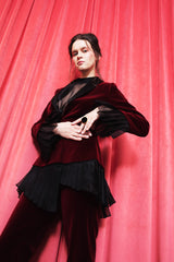 Deep crimson velvet fitted jacket with silk shawl lapel and pleated organza details.