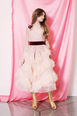 Off the shoulder ball gown in 100 % silk organza with natural ostrich feather trim skirt and crimson velvet belt.