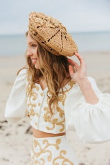 Elegant handcrafted crochet raffia beret adorned with beautiful Baroque floral details for your charmingly unmissable summer look.