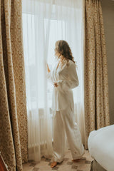 Cut in lightweight silk twill and embellished with pearl white piping, creating an elegant monochrome look these trousers feel effortless yet refined.