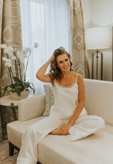 Cut in lightweight silk twill and embellished with pearl white piping, creating an elegant monochrome look these trousers feel effortless yet refined.