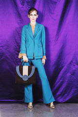 Sky blue elegant boot cut trousers with ornate details at the bottom.