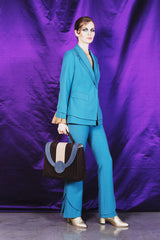 Sky blue elegant boot cut trousers with ornate details at the bottom.