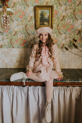 Golden-rose tweed jacket with four front pockets.