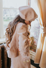 Golden-rose tweed jacket with four front pockets.