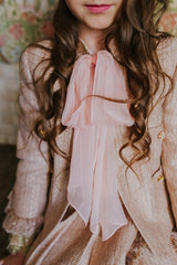 Golden-rose tweed jacket with four front pockets.