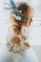 Delicate blue swan feather accessory with crystals.