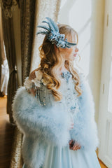 Delicate blue swan feather accessory with crystals.