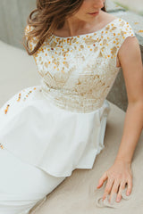 Royal silk duchess top with ruffle bottom that will accentuate the waistline.