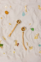 This delicately handcrafted porcelain spoon is hand-gilded and has an extraordinary handle made of smooth driftwood from the Baltic coast.