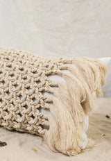 The Riviera Rectangular Cushion is made of linen in ivory white and adorned with a hand-knotted macramé in a natural shade.