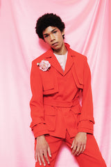 Light scarlet safari style jacket with a buttoned belt and two front pockets.