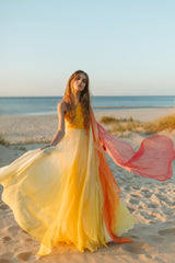 Elegantly soft, sunset-colored one-shoulder empire silk gown.
