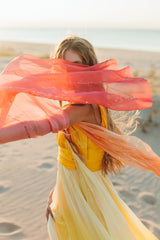 Elegantly soft, sunset-colored one-shoulder empire silk gown.