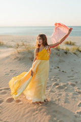 Elegantly soft, sunset-colored one-shoulder empire silk gown.