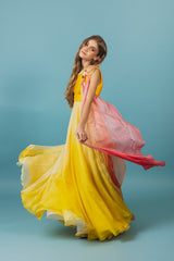 Elegantly soft, sunset-colored one-shoulder empire silk gown.