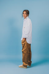 White twill cotton shirt with baseball hem that's longer on the back and rounds up on the sides.