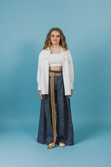 White satin shirt with a scoped hemline that is longer in the back and rounds up on the sides.