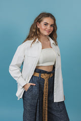 White satin shirt with a scoped hemline that is longer in the back and rounds up on the sides.