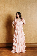 A romantic blush rose ruffle dress with a V-neckline.
