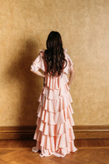 A romantic blush rose ruffle dress with a V-neckline.