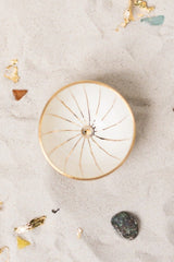 This delicately handcrafted porcelain bowl is adorned with a hand-painted golden motif of the Golden City.