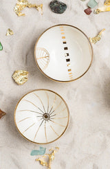 This delicately handcrafted porcelain bowl is adorned with a hand-painted golden motif of the Golden City.