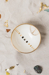 This delicately handcrafted porcelain bowl is adorned with a hand-painted golden motif of the Golden City.