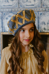 Exquisite swan blue velvet beret with golden quilting.