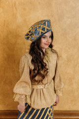 Exquisite swan blue velvet beret with golden quilting.