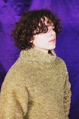 Hand-knitted textured sweater in shimmering golden shade with the softest silk lining for comfort.