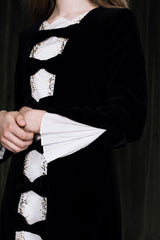 Midnight black mini dress with silk inset and pleated back.