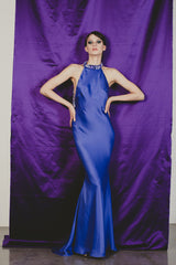 Magnificent purple fitted sheath gown with extreme low cut back.